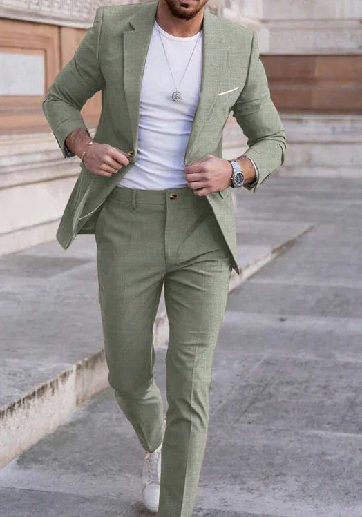 Man wearing light green slim-fit suit with white t-shirt and sneakers, modern street style