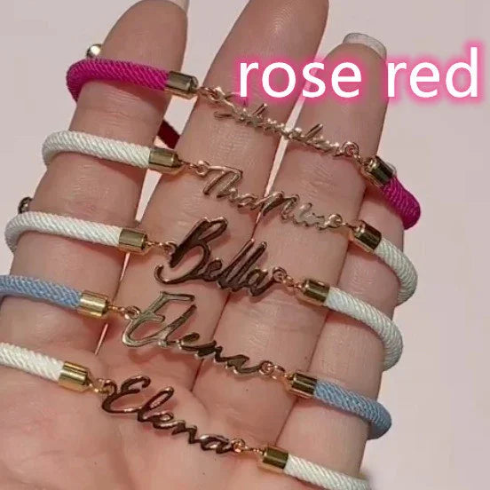 Rose red, white, and blue cord bracelets with custom gold-tone nameplates, adjustable fit