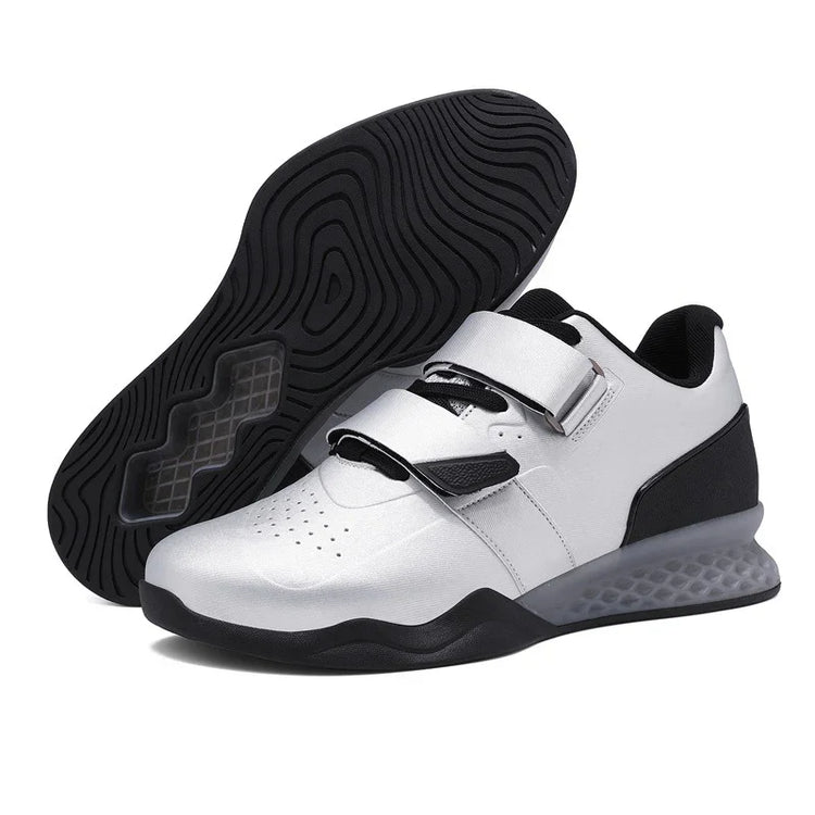 Modern white and black low-top sneakers with velcro straps and textured sole