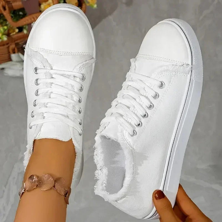 White canvas sneakers with frayed edges, lace-up design, casual streetwear style