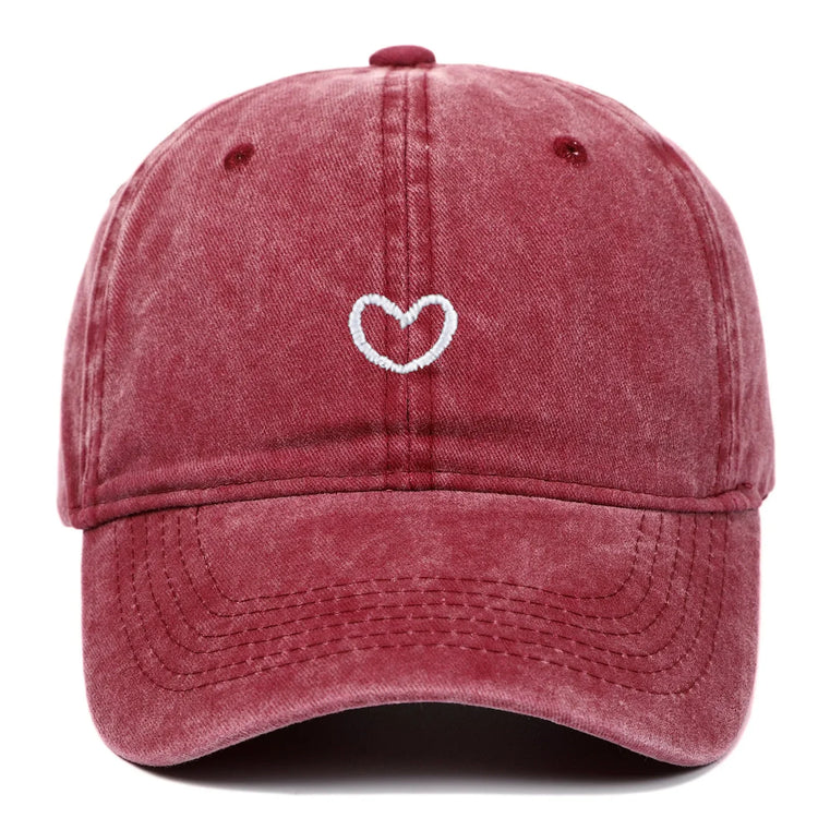 Washed red cotton dad hat with white embroidered heart, curved brim, relaxed fit