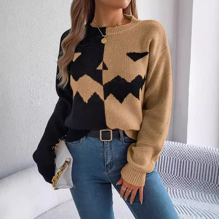 Two-tone knit sweater with abstract face design, relaxed fit, paired with blue jeans
