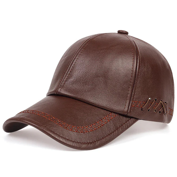 Brown leather baseball cap with curved brim, contrast stitching, and metal eyelet accents.