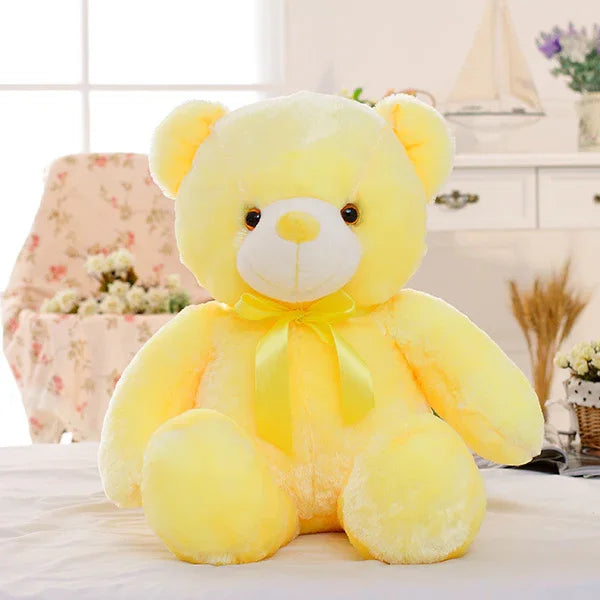 Plush yellow teddy bear with soft fur and satin ribbon, cozy and oversized fit.