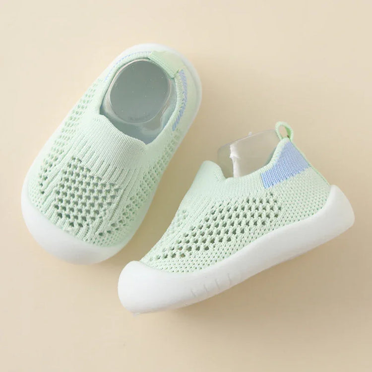 Light green knitted slip-on baby shoes with white soles and breathable mesh design
