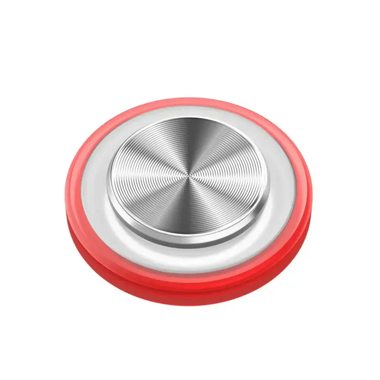 Red and silver circular metal button with concentric pattern and smooth finish