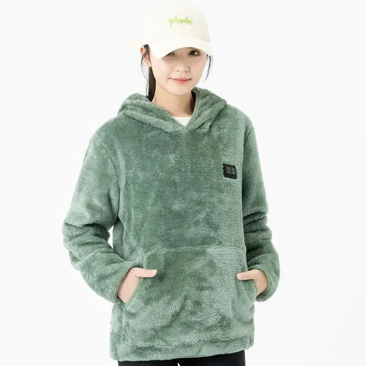 Woman wearing loose fit sage green plush fleece hoodie with front pocket and hood