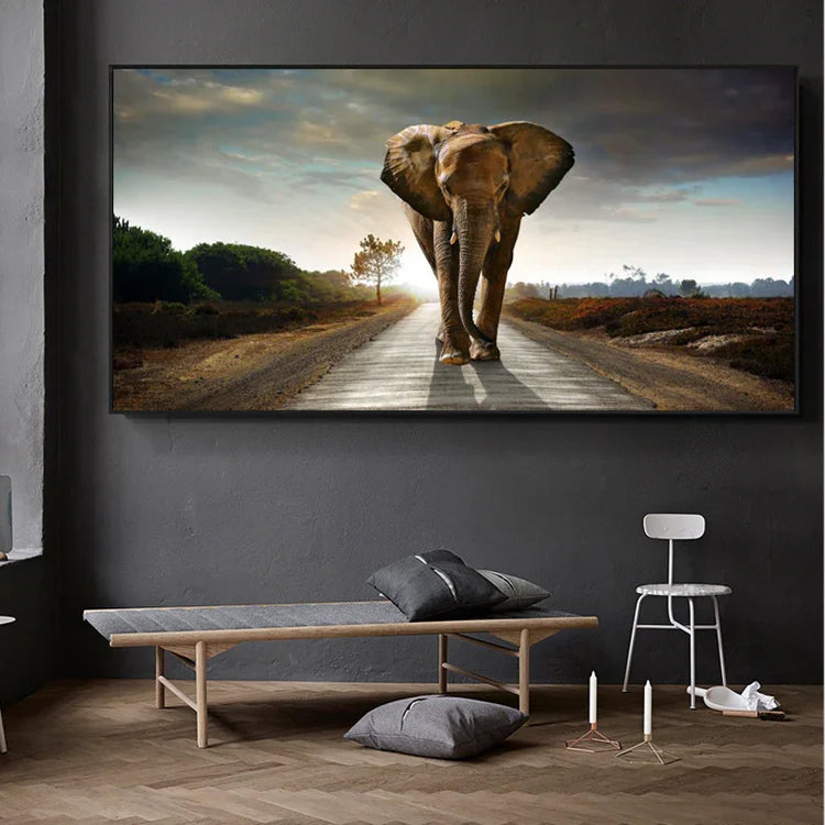 Modern minimalist living room with a large wall art featuring an elephant on a road, neutral decor, gray seating, and wooden flooring.