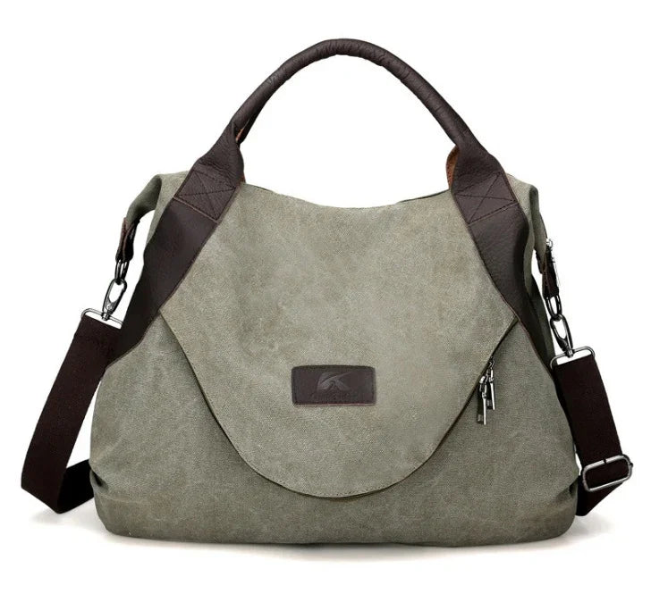 Olive green canvas shoulder bag with brown leather trim and adjustable strap, relaxed fit.