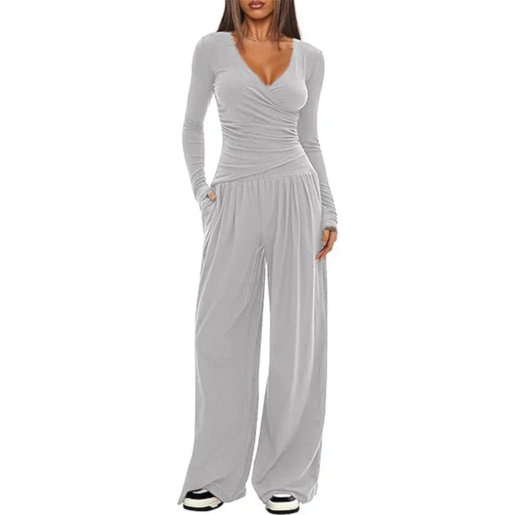 Woman wearing light gray long sleeve wrap top and wide leg pants lounge set
