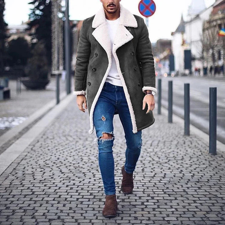 Man wearing dark shearling-lined trench coat, ripped skinny jeans, brown boots, street style