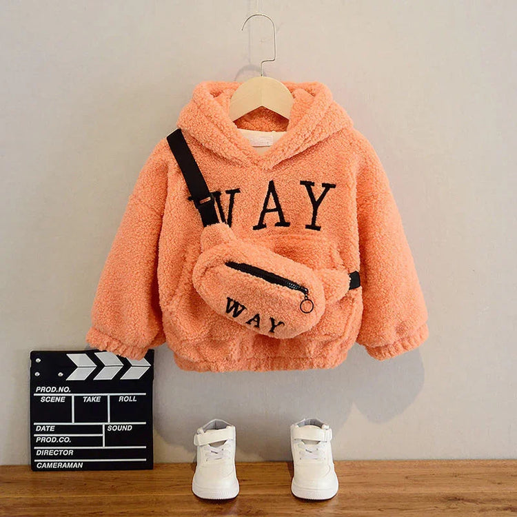 Peach sherpa hoodie with bold lettering, matching fuzzy crossbody bag, and white sneakers