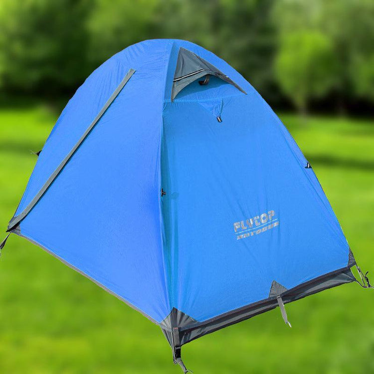 Blue dome-shaped polyester outdoor tent with grey accents, set on green grass