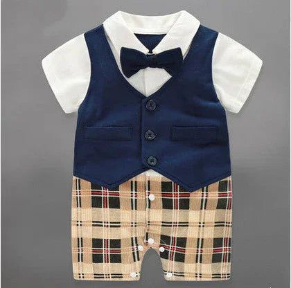 Baby romper with navy vest, short sleeves, plaid shorts, and detachable bow tie