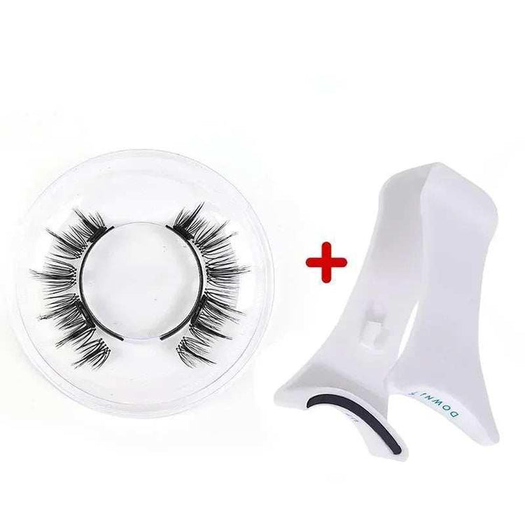 Black synthetic false eyelashes with white plastic lash applicator tool on white background