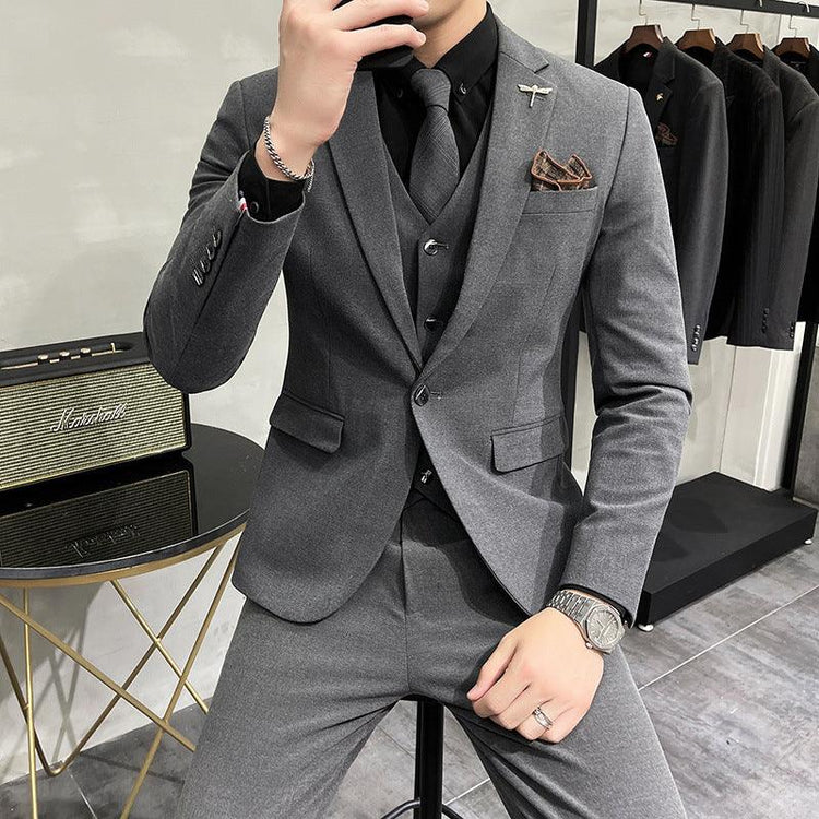 Slim fit gray suit with matching vest, black shirt and tie, modern formal menswear