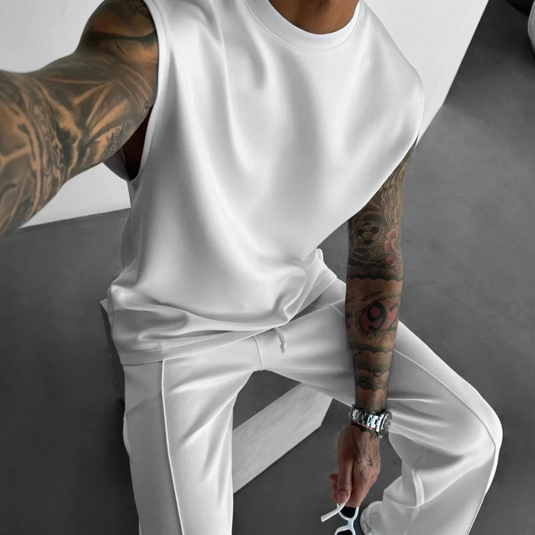 Man wearing white sleeveless top and matching white pants, relaxed fit, soft material