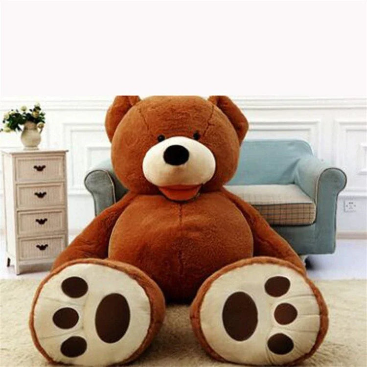 Large brown plush teddy bear with soft fabric, seated in a modern living room setting