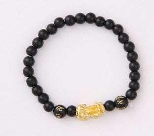 Black beaded bracelet with gold accents and engraved characters, stretch fit.