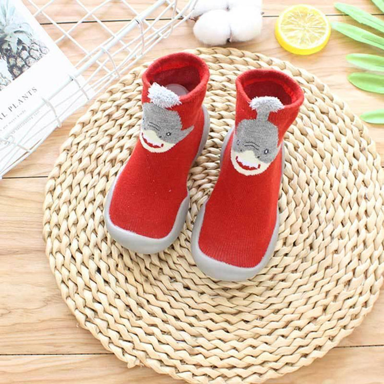 Red knit baby sock shoes with gray cartoon shark design and gray rubber soles
