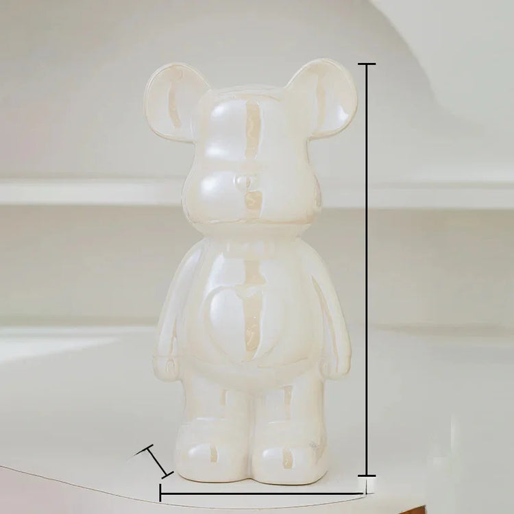 Glossy cream ceramic bear figurine with measurement lines, minimalist decor setting