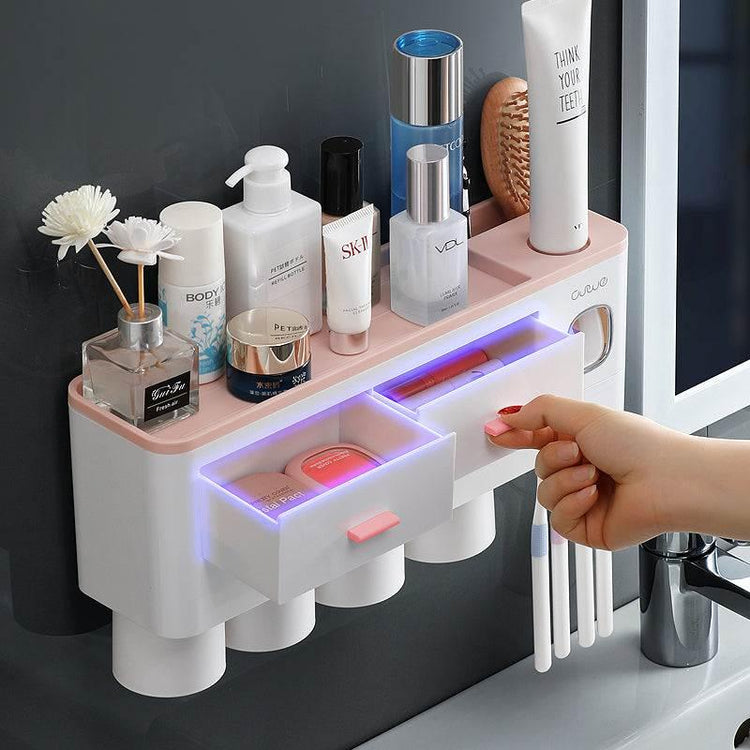 Wall-mounted bathroom organizer with pink and white plastic compartments and open drawers
