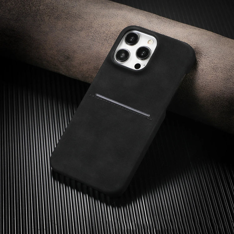 Matte black suede phone case with minimalist design and slim fit on ribbed black surface