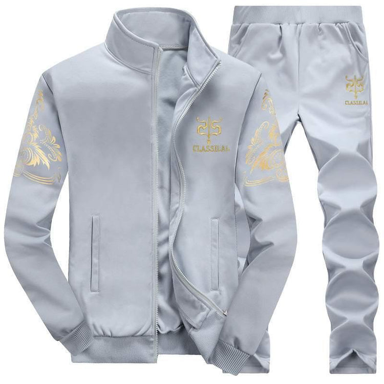 Light grey tracksuit set with gold embroidered patterns, zip-up jacket, and matching pants