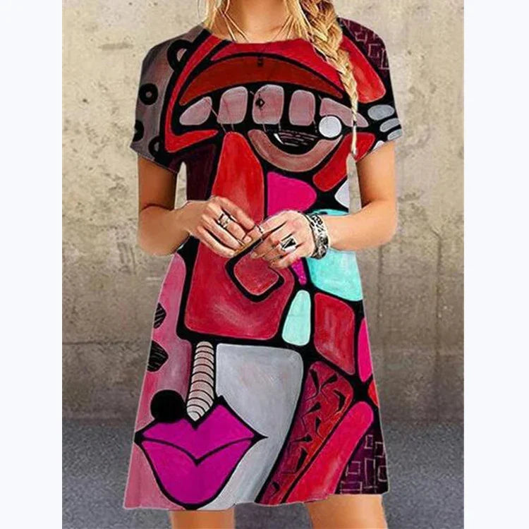 Woman wearing a short sleeve, loose-fit dress with bold abstract graphic print in red, pink, black, and turquoise colors.