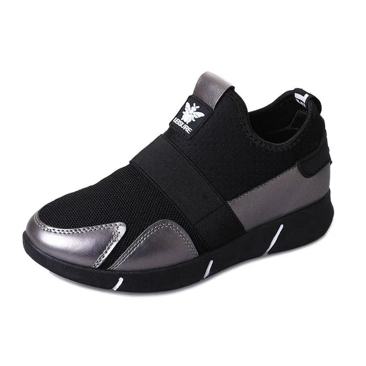 Modern slip-on sneaker with black mesh upper, metallic silver accents, and cushioned sole