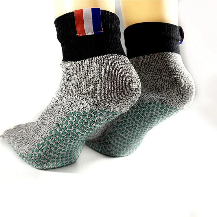 Gray non-slip athletic socks with black cuffs, cushioned sole, and color block tab detail.