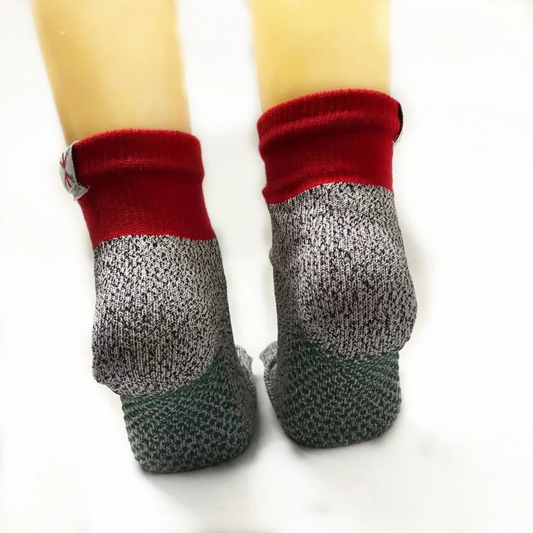 Ankle-length socks with red cuffs, gray and green knit, and a snug athletic fit.