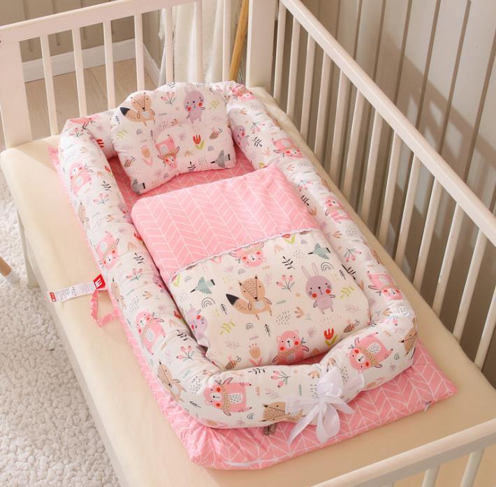 Pink and white baby bedding set with animal print, soft cotton material, fits a crib.