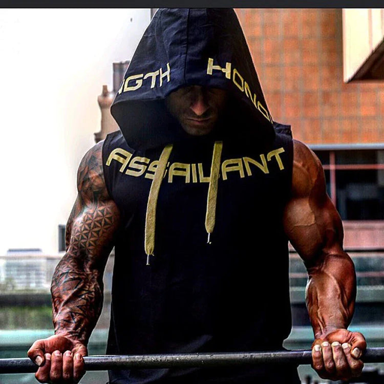 Muscular man in a black sleeveless hooded tank top with bold yellow text and drawstrings, athletic fit