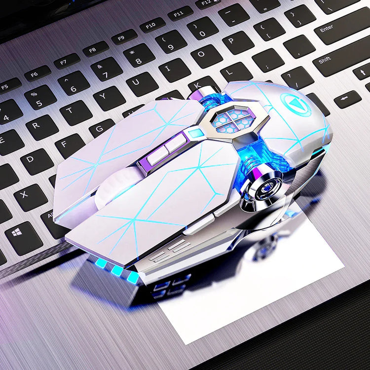Futuristic white wired gaming mouse with blue LED lights on a silver laptop keyboard