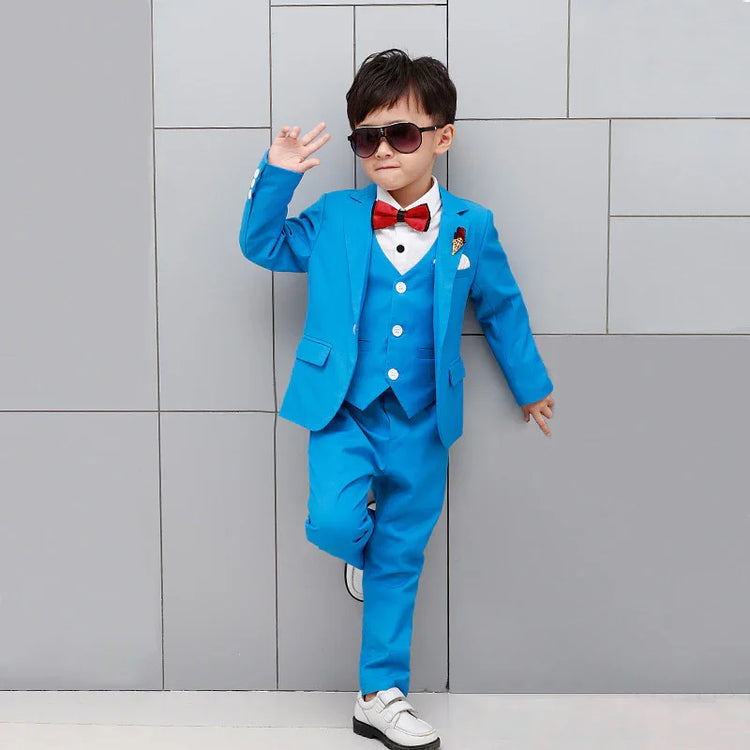 Young boy in tailored bright blue suit with red bow tie, white shirt, slim fit, modern style