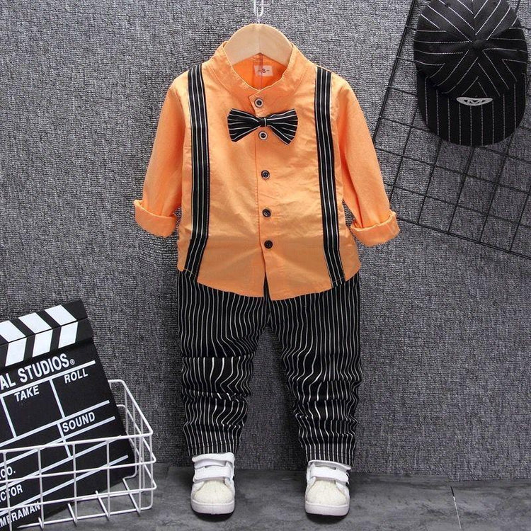 Kids outfit with orange button-up shirt, black pinstripe pants, bow tie, and matching cap