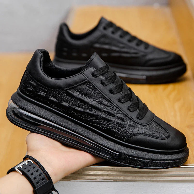Black chunky sneaker with textured faux leather, thick sole, modern streetwear style