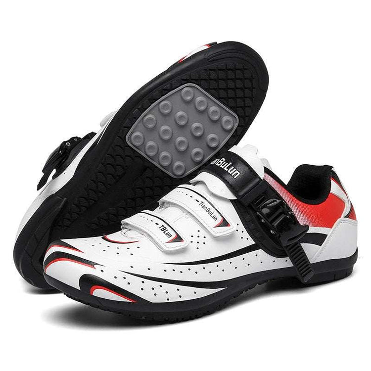 White and red cycling shoes with black soles, breathable perforations, secure velcro and buckle straps.