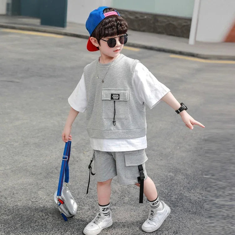Boy wearing grey streetwear vest and shorts set with white t-shirt, sporty fit, outdoors