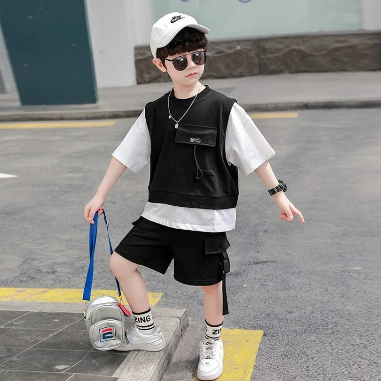 Kid wearing black vest over white t-shirt and black cargo shorts, sporty streetwear style