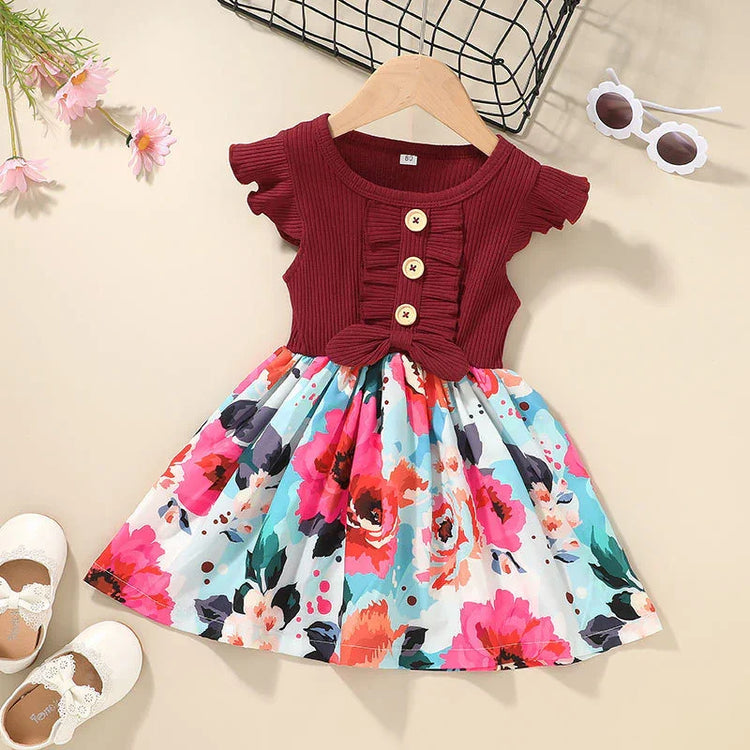Girls’ short-sleeve burgundy and floral cotton dress with ruffled bodice and bow detail.