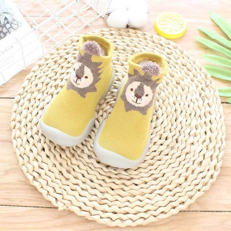 Yellow knit toddler sock shoes with lion face pattern and flexible rubber sole, slip-on fit