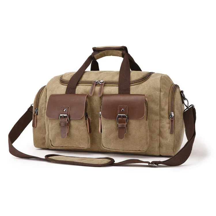 Khaki canvas duffel bag with brown leather accents, adjustable shoulder strap, and front pockets.