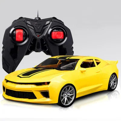 Yellow remote control car with black racing stripes and black controller in background