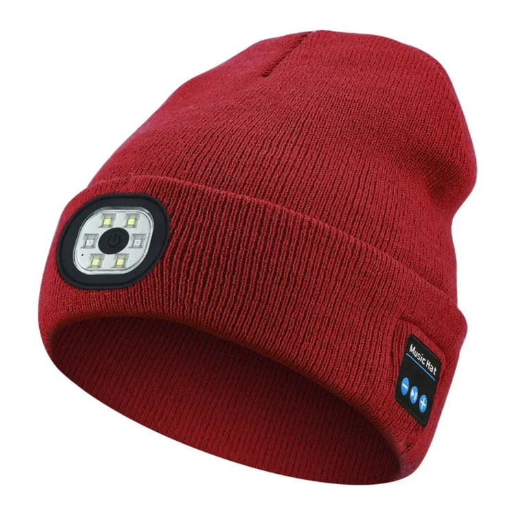 Red knit beanie with built-in LED light and Bluetooth speaker, tech streetwear style.