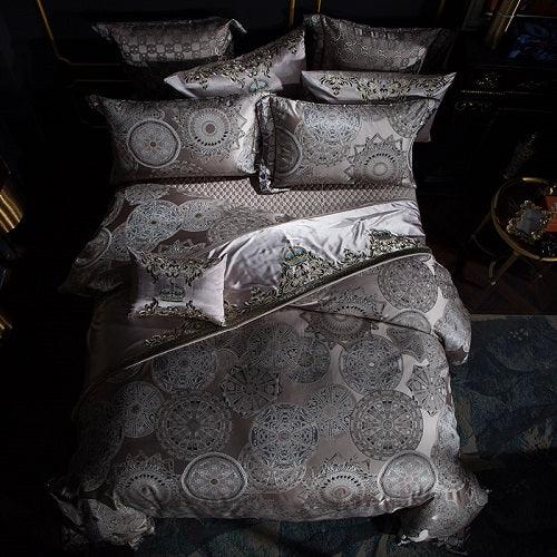 Satin bedding set in silver gray with intricate mandala pattern, includes pillows and duvet cover.
