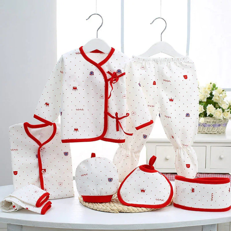 White cotton baby clothing set with red trim, long sleeves, pants, and cute printed patterns