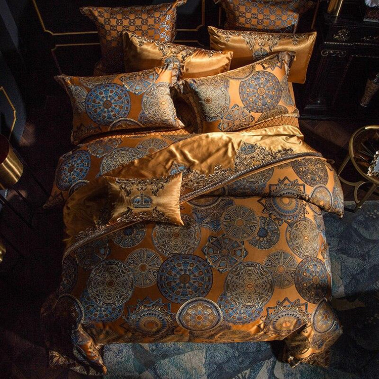 Luxurious gold and blue satin bedding set with intricate geometric patterns and elegant fit.