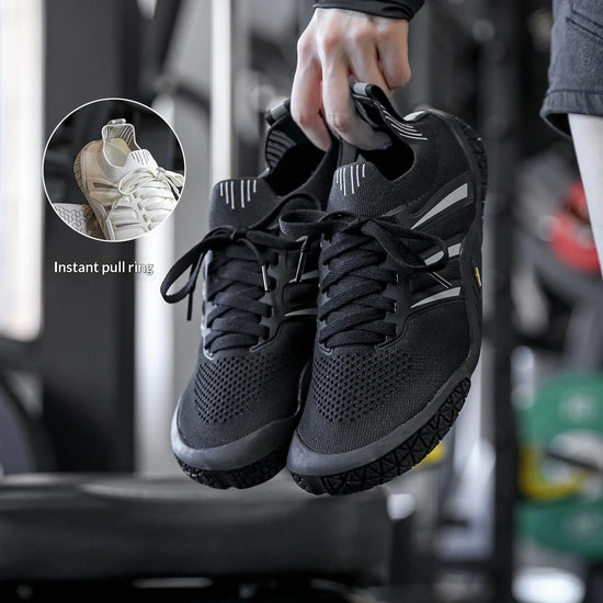 Black athletic sneakers with mesh material, reflective accents, and instant pull ring for easy fit